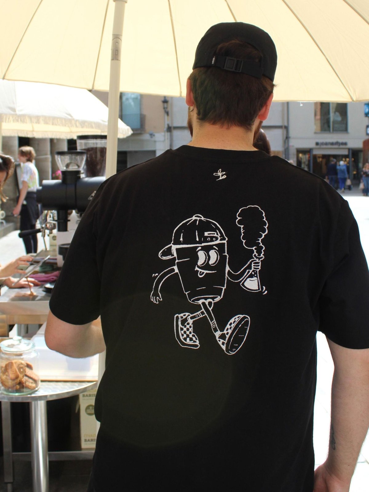 Camiseta de staff con ilustración bordada en la espalda para una cafetería